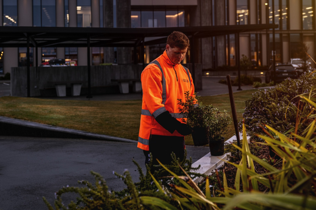 a man in high-vis gear looking after plants